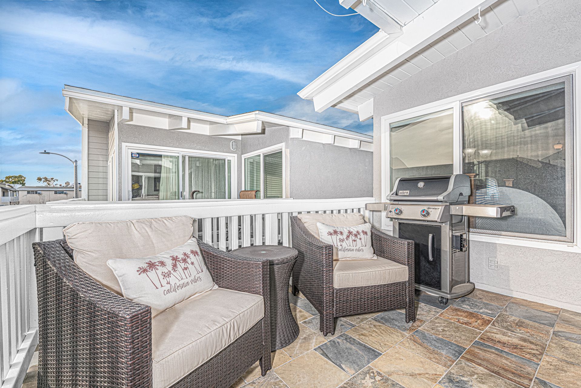 Bright balcony seating and outdoor grill